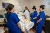 Nursing students practice patient care in lab